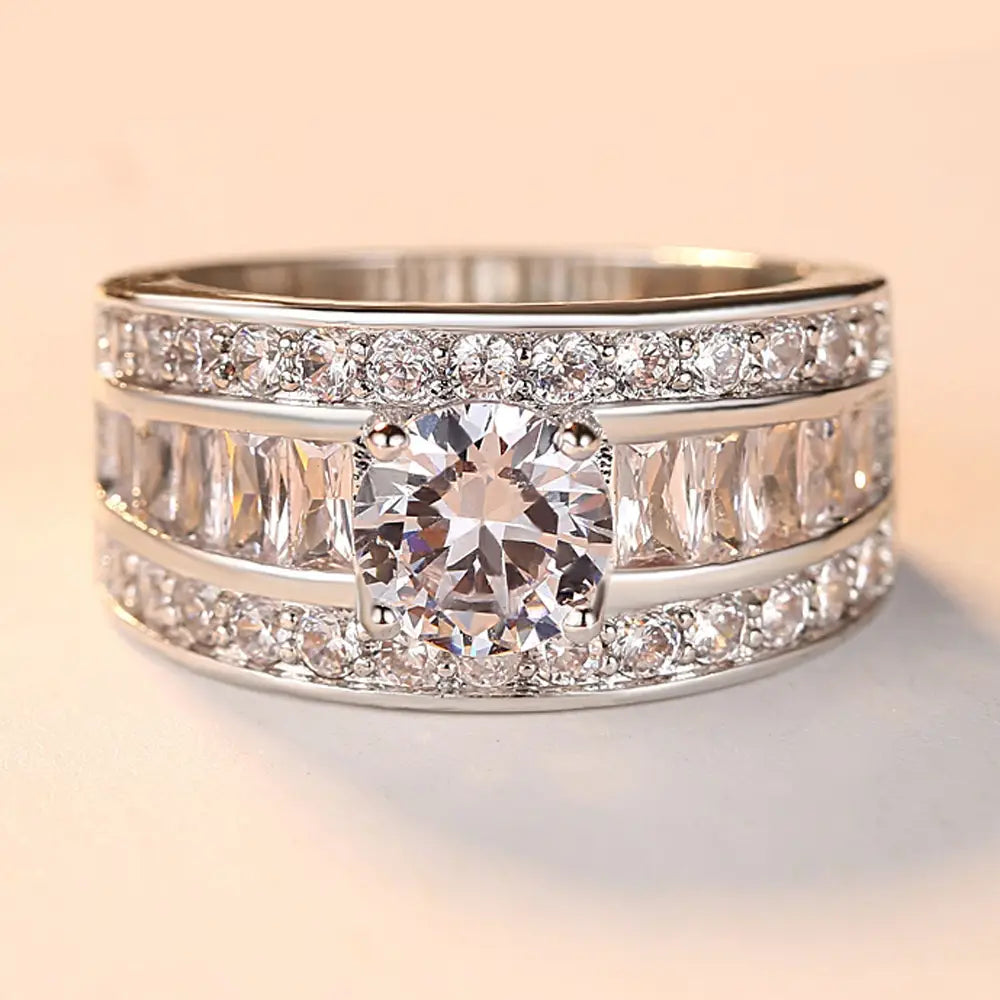 Vintage zircon heart arrow adjustable silver ring featuring a stunning silver-toned band with a central round-cut diamond flanked by baguette and pavé-set diamonds in three distinct bands.