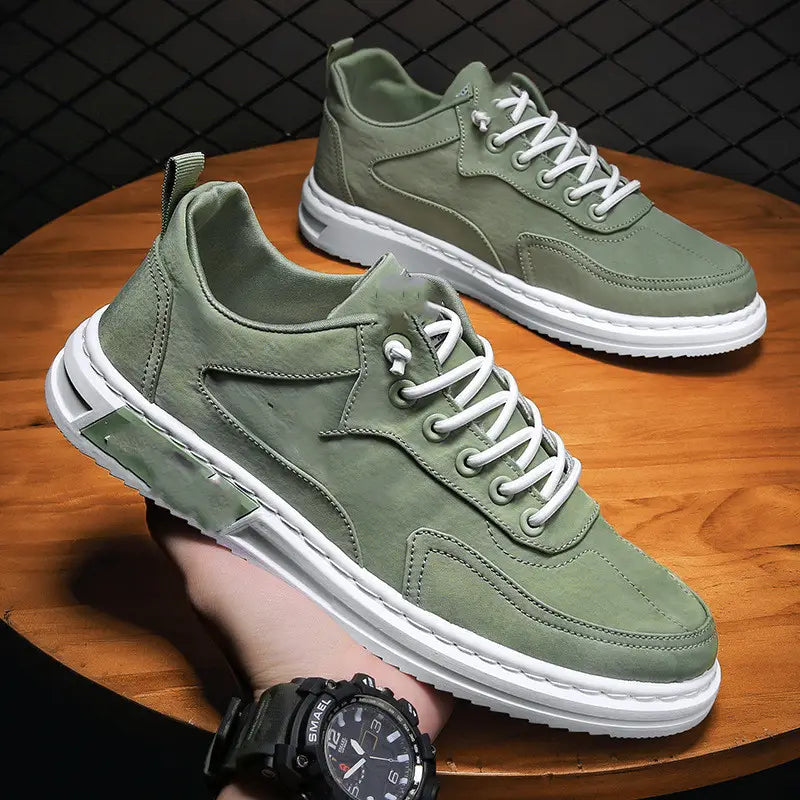 Olive green suede canvas sneakers with white laces and chunky white rubber sole designed as trendy casual sports shoes.