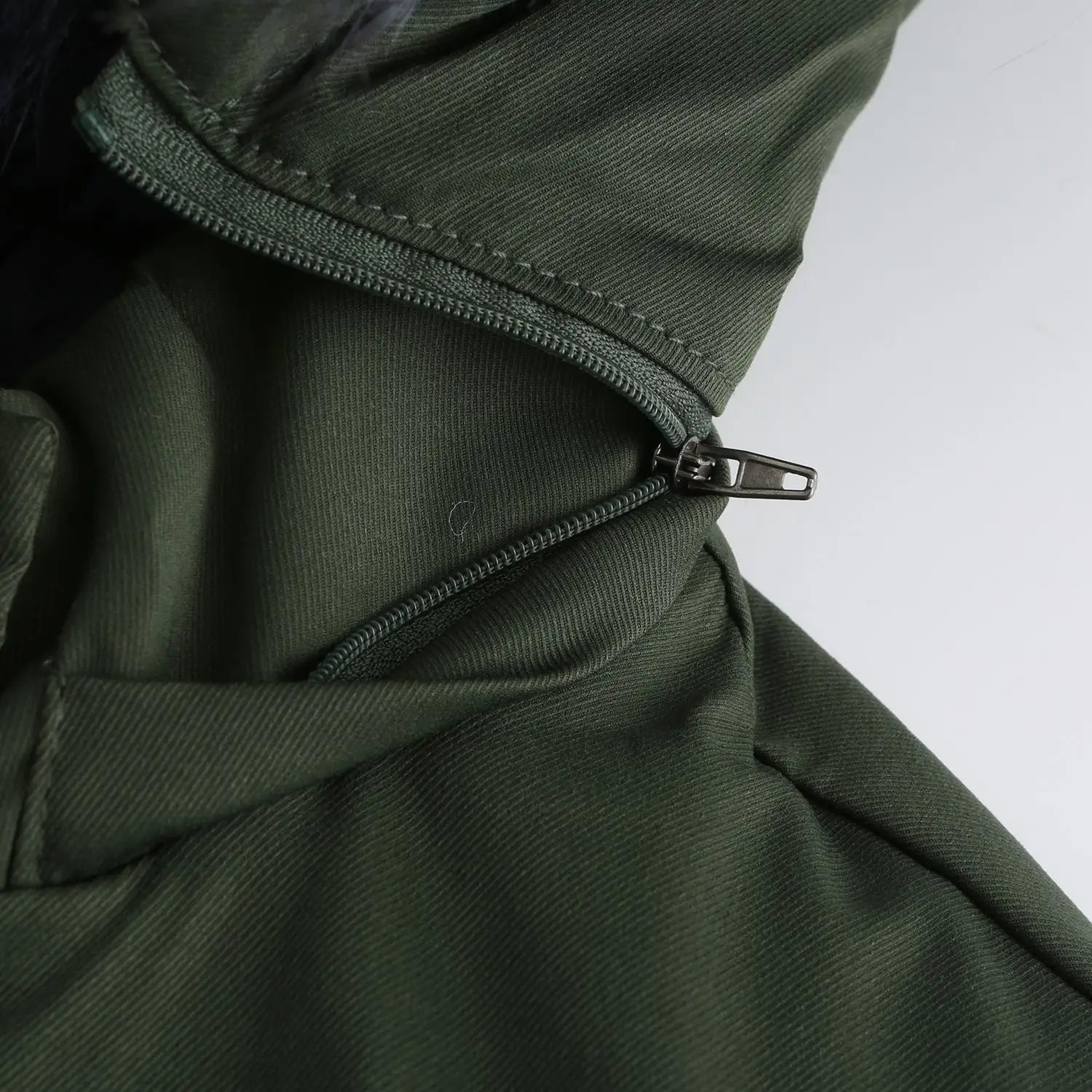 Dark green nylon reversible fur collar quilted parka with a black zipper pull.