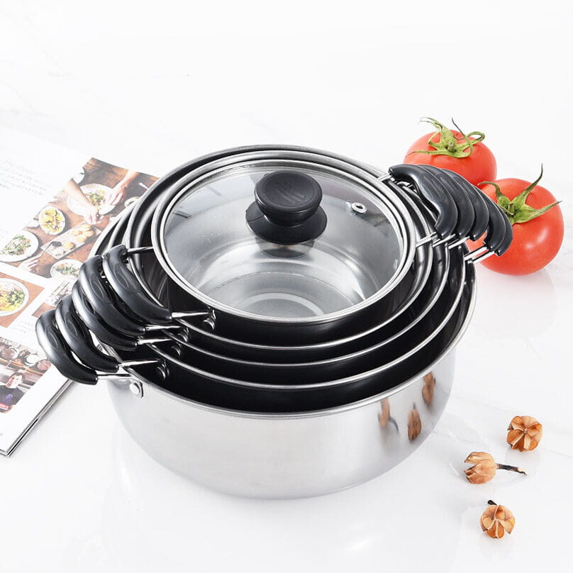 Set of five nested stainless steel induction cookware pots with black handles and glass lids.