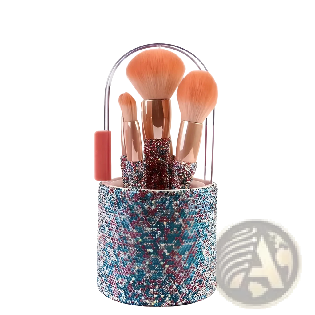 A cylindrical makeup brush holder encrusted with blue pink and silver rhinestones featuring a clear handle and coral grip