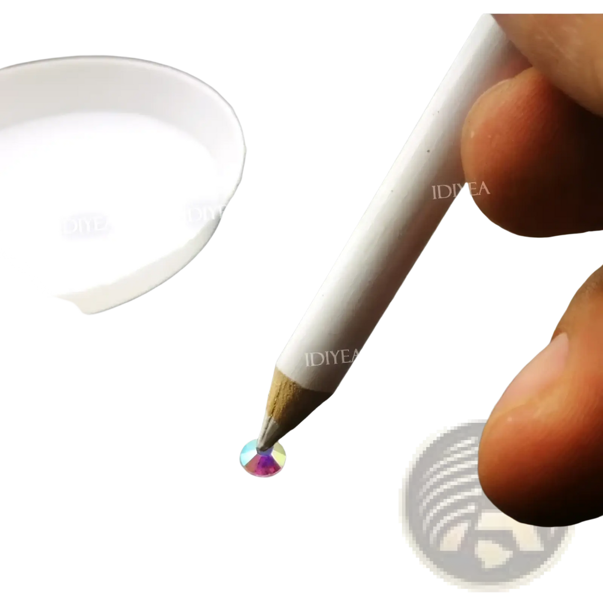 White wooden-tip pencil from diamond painting tool set applying adhesive to a multicolored rhinestone