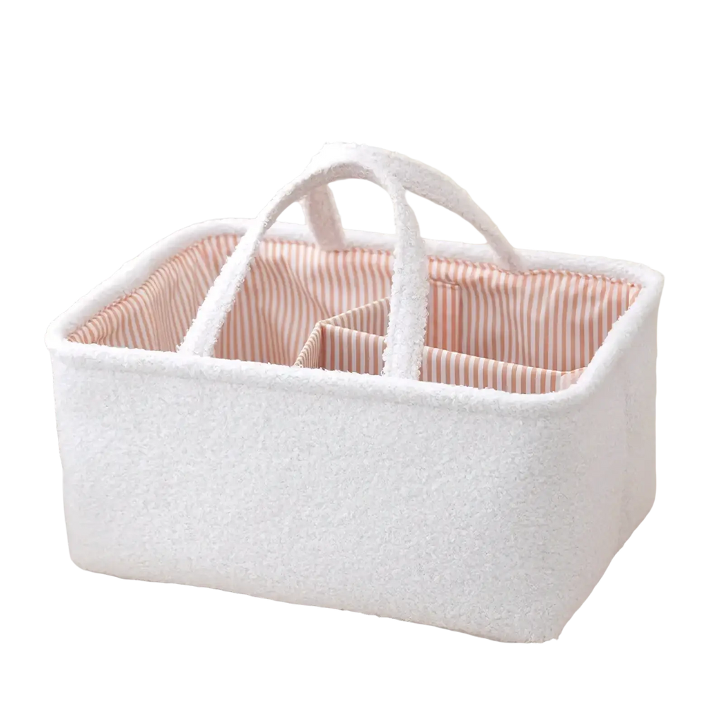 White textured fabric diaper caddy organizer with pink and white striped interior lining for nursery storage
