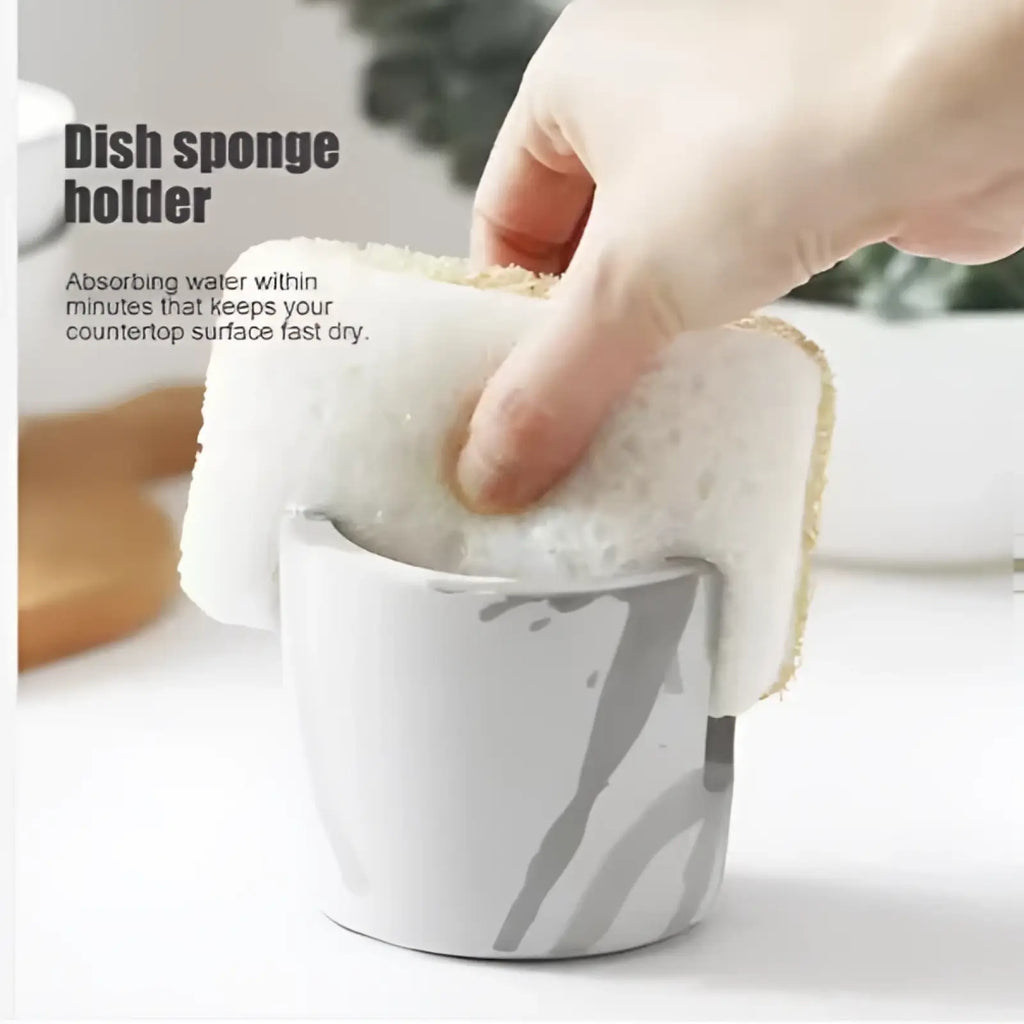 White and gray marbled ceramic Diatom Mud sponge rack with a textured absorbent sponge in a curved sink caddy holder