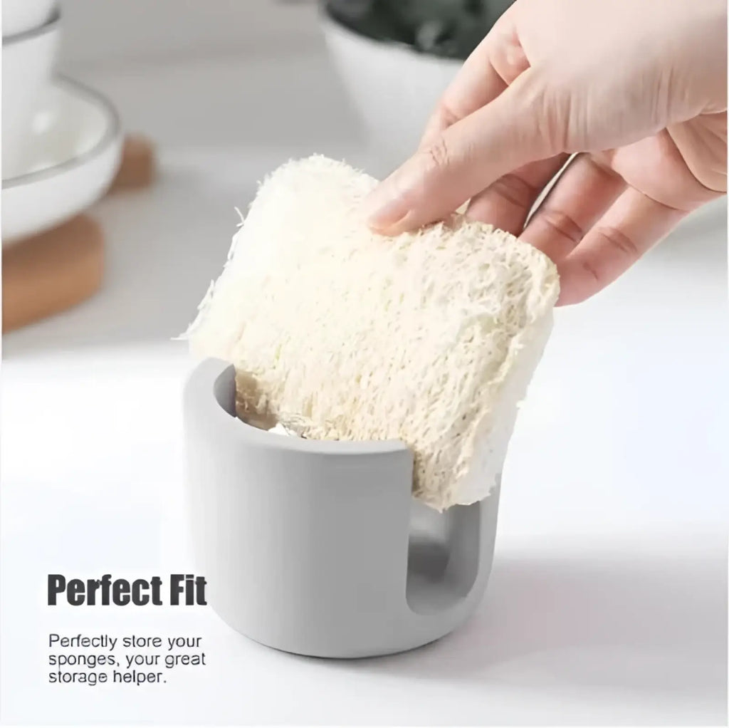 Beige fibrous loofah sponge held above gray diatom mud sponge rack ceramic sink caddy holder for kitchen use