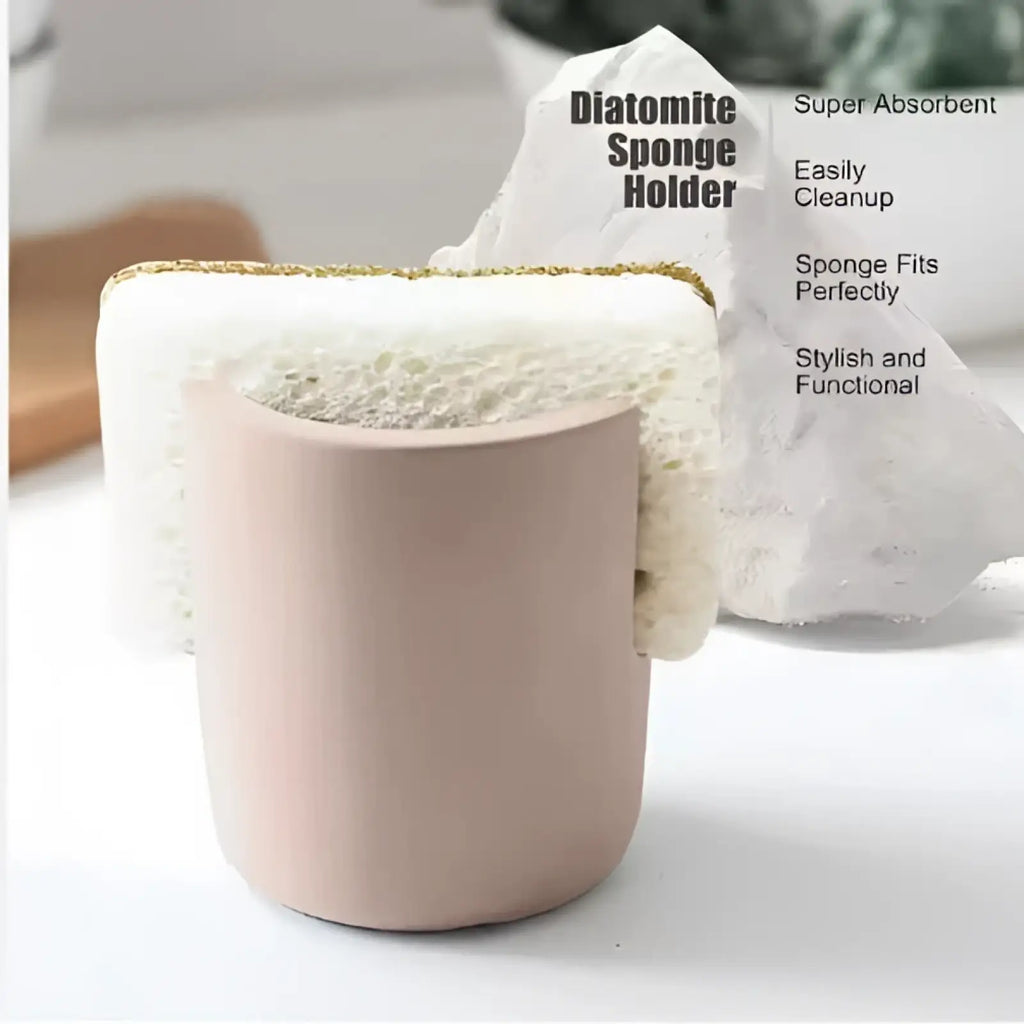 A matte pink diatom mud sponge rack with gold trim designed to hold a white diatomite sponge for kitchen sink use