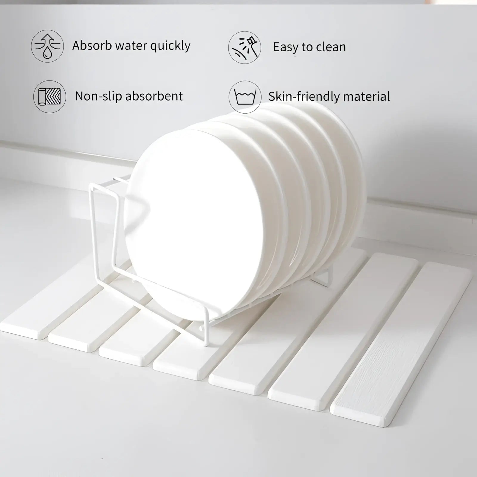 White circular diatomaceous earth coasters stacked in wire rack on foldable stone dish drying mat with non-slip base