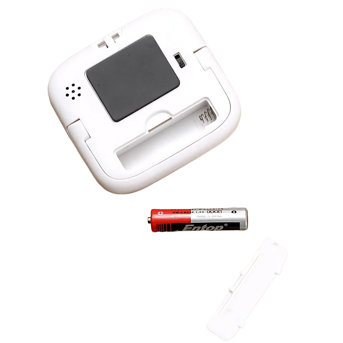 White plastic digital kitchen timer with black display battery compartment entop aa battery and cover shown from back side