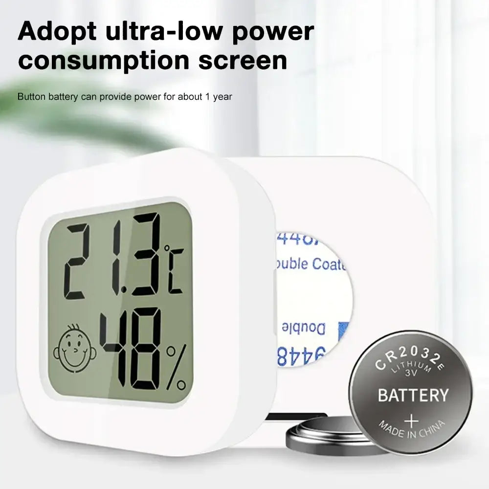 White square digital thermometer and hygrometer room sensor with green screen showing 21.3°c and 48% humidity measurement range