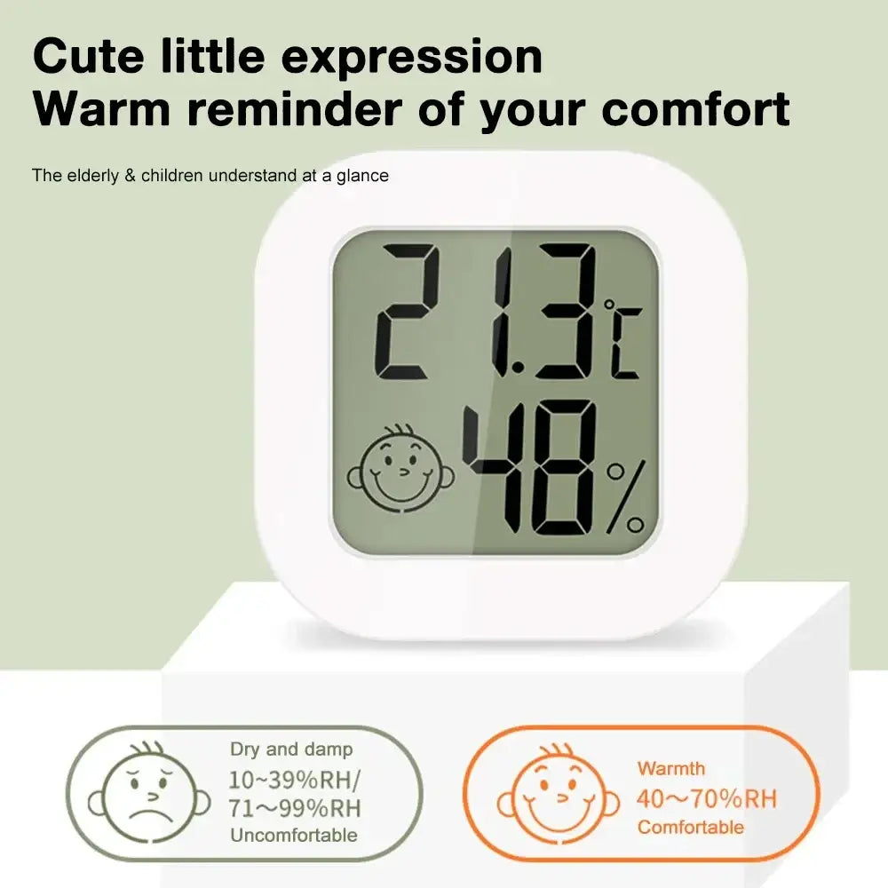 Digital thermometer and hygrometer room sensor in white displays 21.3°c and 48% humidity with smiling face icon
