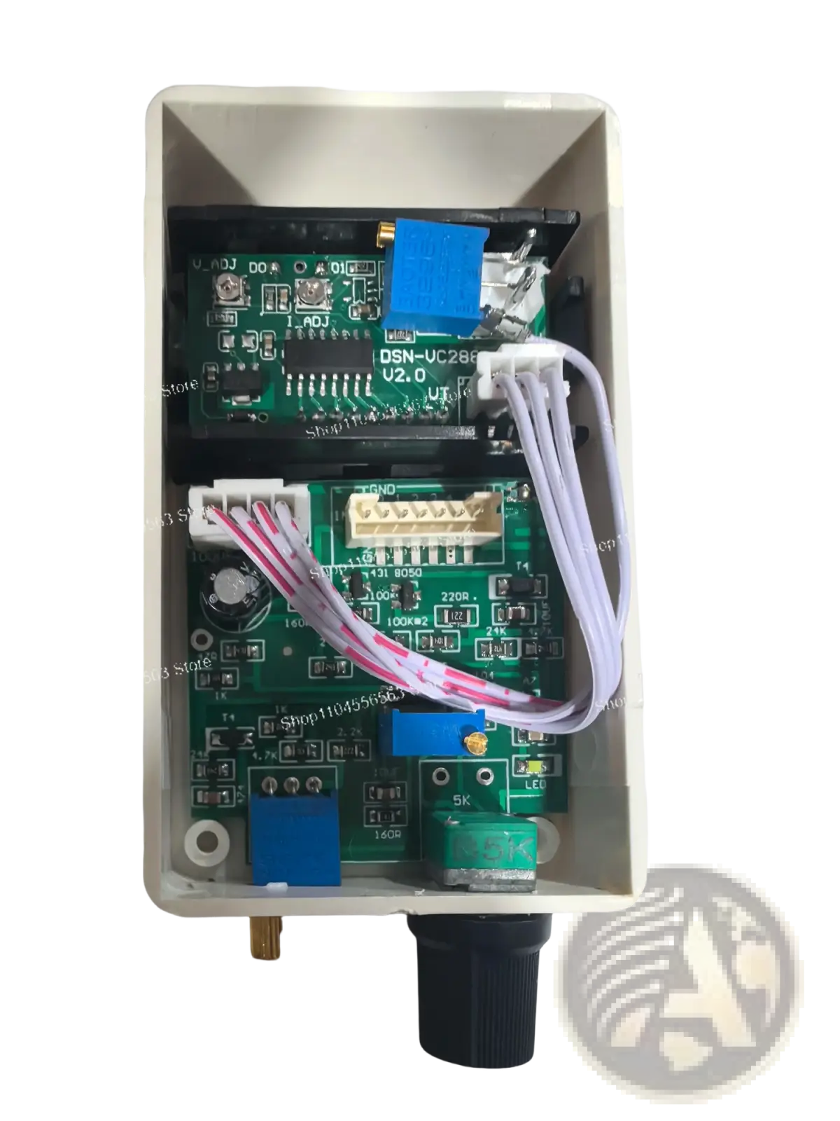 White plastic enclosure housing green circuit boards labeled dsn-uc28f v2.0 for digital voltage current regulator 50a 60a 100a