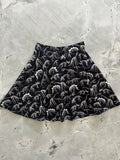 Black vintage cotton skater skirt with white dinosaur skeleton pattern featuring a flared design