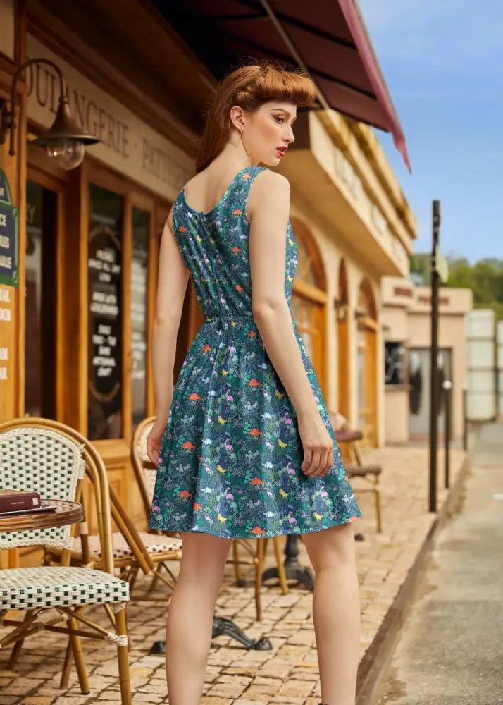 A teal floral print sleeveless cotton fit and flare dress with pockets and a fitted bodice for casual wear