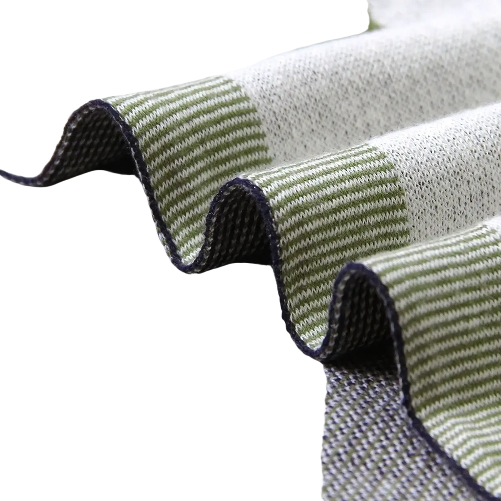 Dinosaur knit baby blanket back side showing soft cotton fabric with subtle green white stripes and dark blue edge