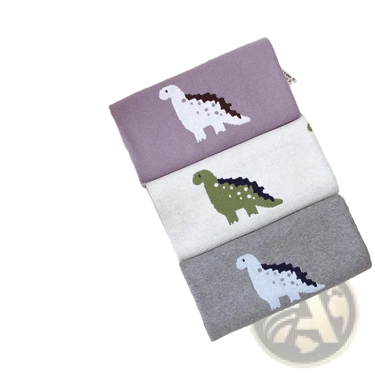 Three pairs of soft knitted cotton children’s socks in muted purple off-white and gray with dinosaur designs