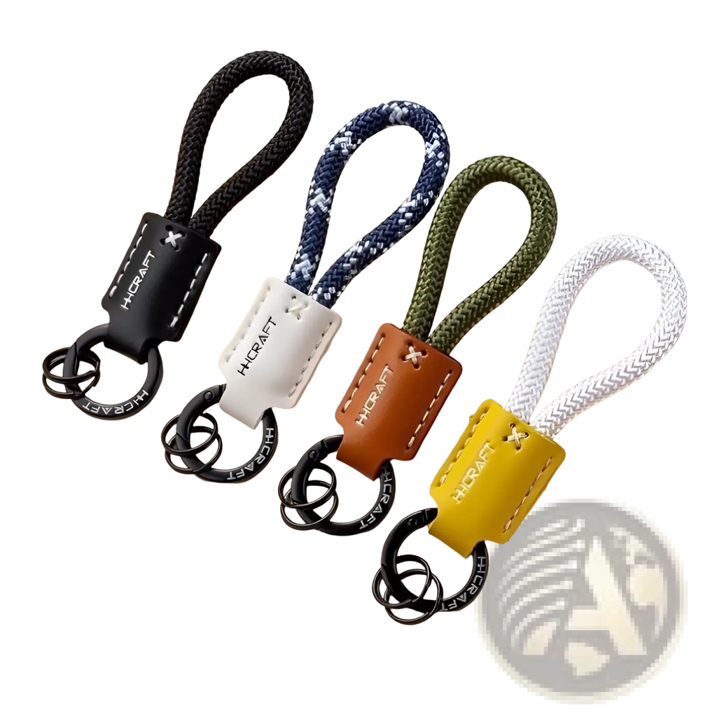 Set of four dinosaur leather braided keychains with black navy blue white and olive green rope loops and metal rings