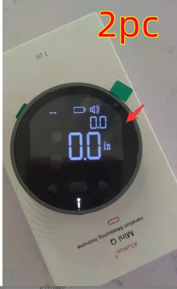White circular Arbaglobal digital lcd electronic distance measuring ruler with black screen and blue numerals showing 0.0 in