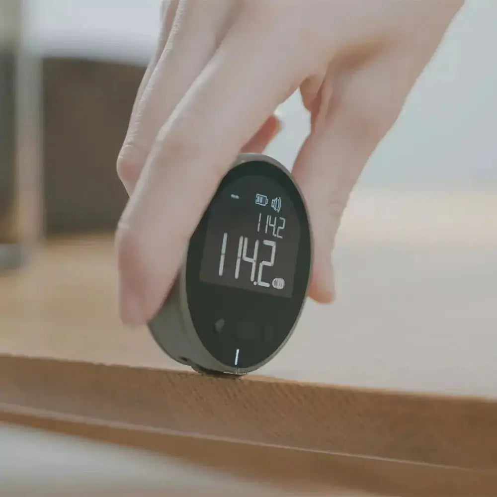 Arbaglobal digital lcd electronic distance measuring ruler is a black digital tape measure with a sleek rounded casing and illuminated display