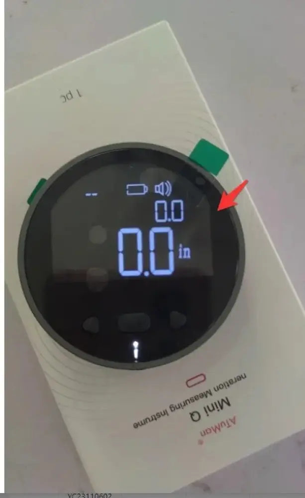 White rectangular Arbaglobal digital lcd electronic distance measuring ruler with circular display showing zero inches and battery icon