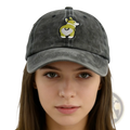 A faded gray distressed denim baseball cap featuring an embroidered corgi with green and white details on the front