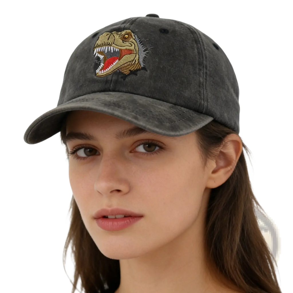 A dark gray distressed dinosaur baseball cap with an embroidered tan and red T-rex head on the front