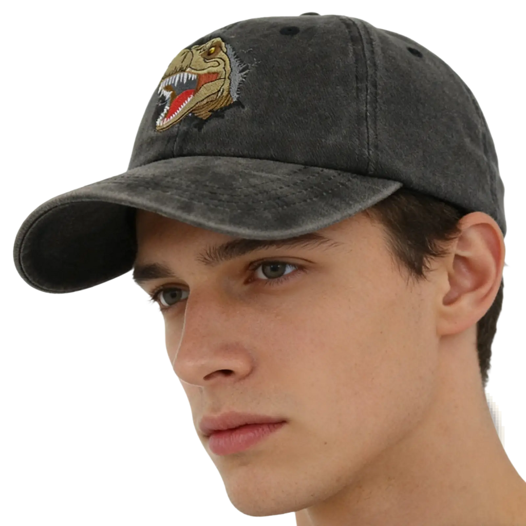 Dark gray distressed baseball cap with embroidered yellow red and black t-rex head titled distressed dinosaur baseball cap