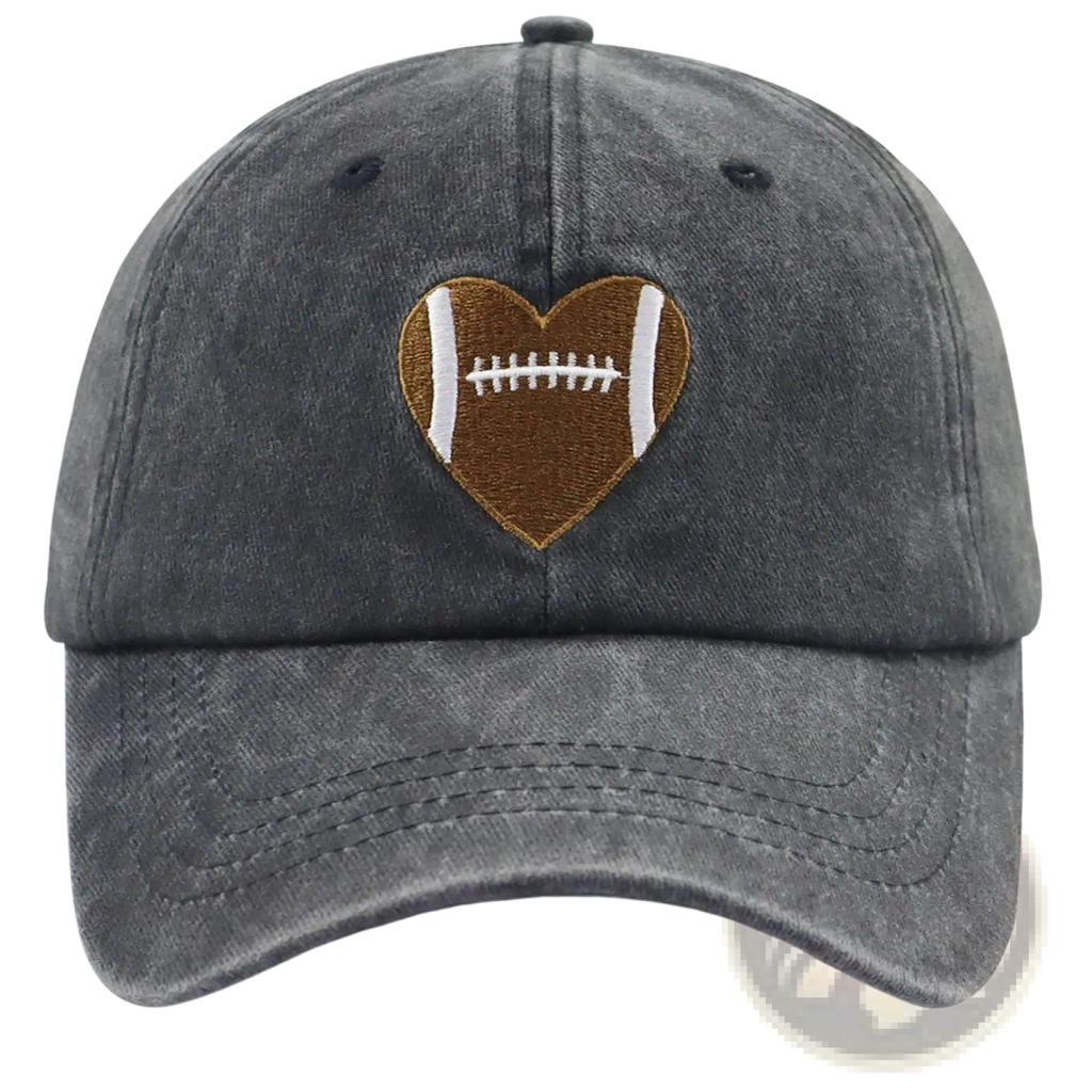 A dark gray distressed denim baseball cap with a heart-shaped football embroidered patch in brown and white stitching