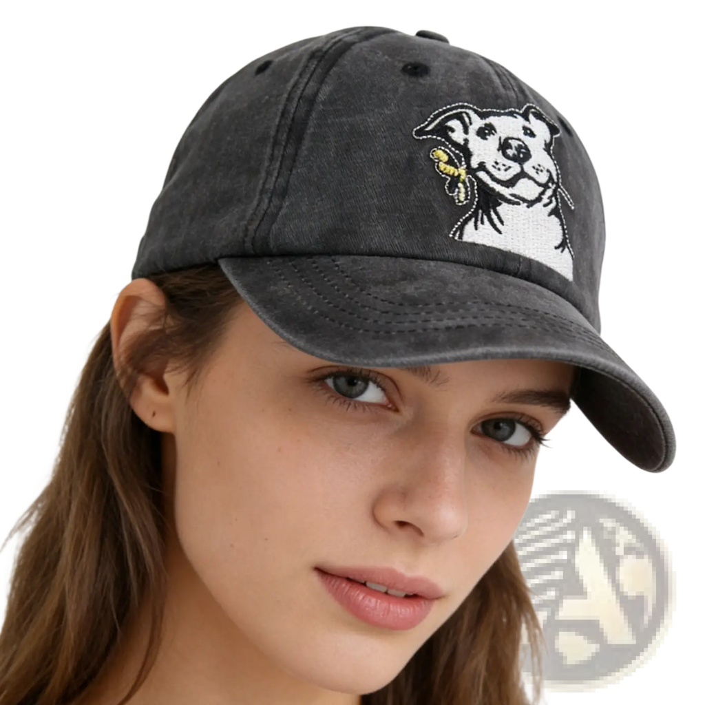 Dark gray distressed baseball cap with white embroidered pitbull face holding a yellow banana, distressed french bulldog style