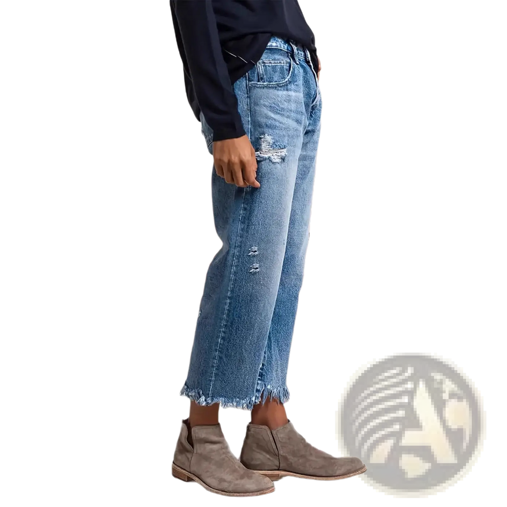 Distressed gray ripped straight jeans in medium-wash blue denim with distressed patches and a frayed hem