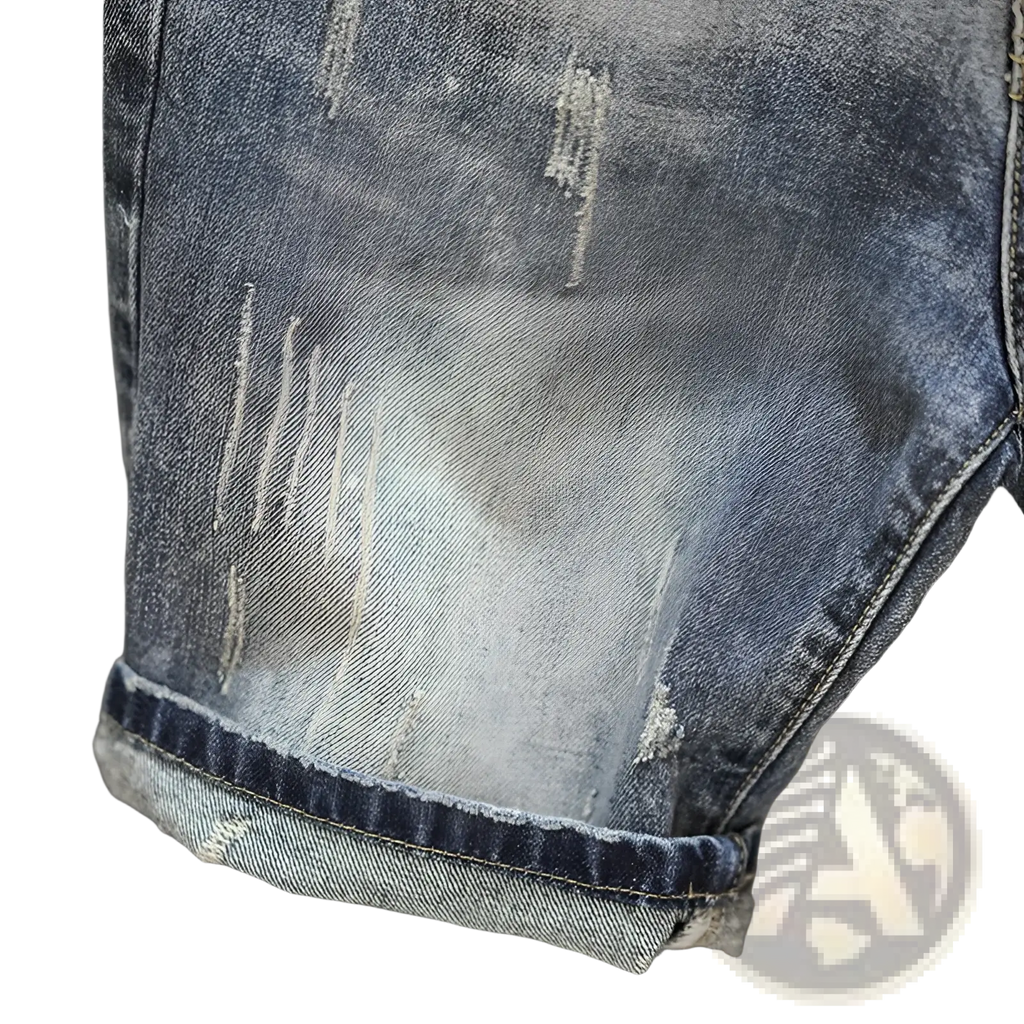 Distressed maple leaf denim shorts in blue with faded wash and intentional rips on distressed denim material