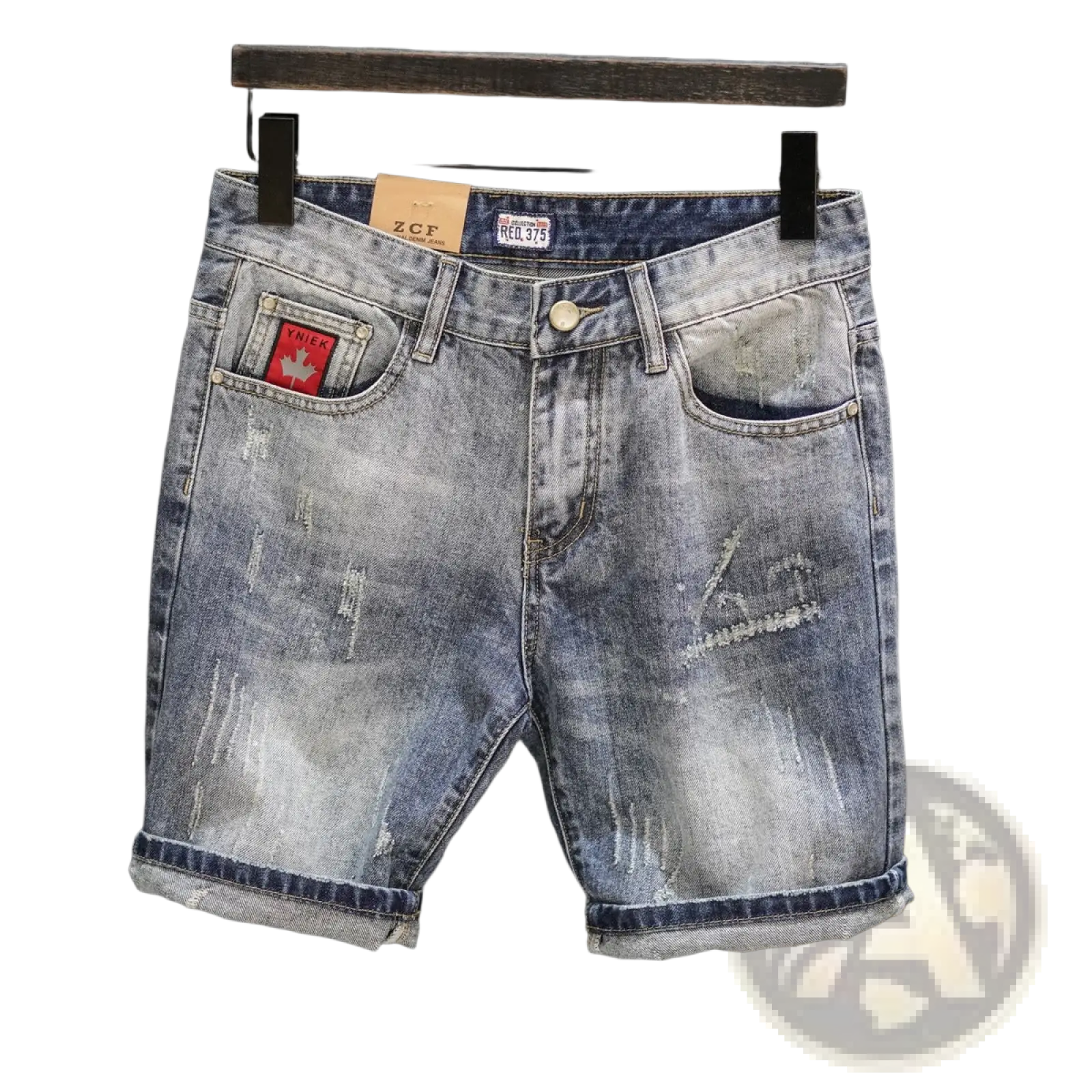 Distressed blue denim shorts with rolled cuffs and a red maple leaf patch on the front pocket