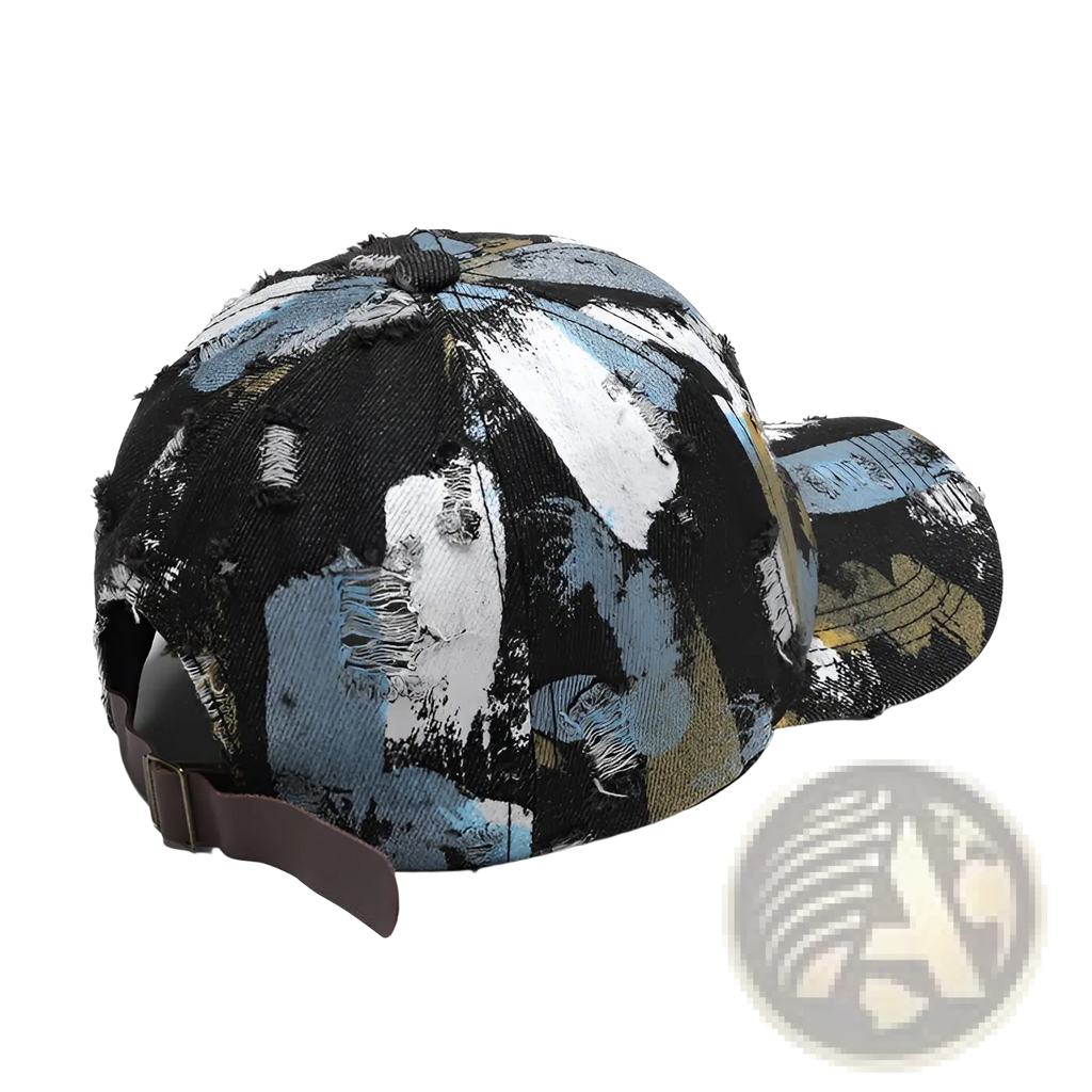 A distressed cotton baseball cap with a bold abstract paint splatter pattern in black blue white and gold