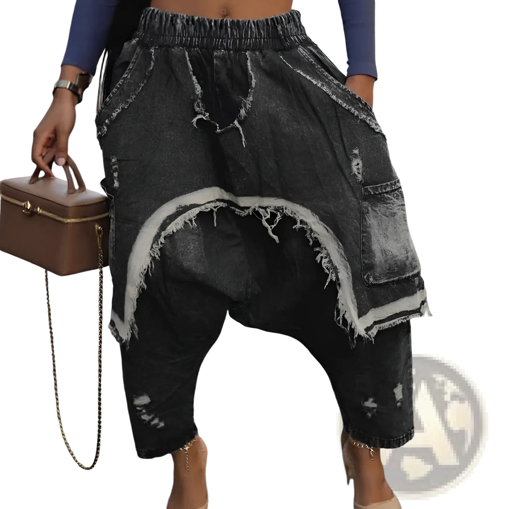 Distressed patchwork denim harem pants in dark wash with frayed edges and a casual, relaxed fit