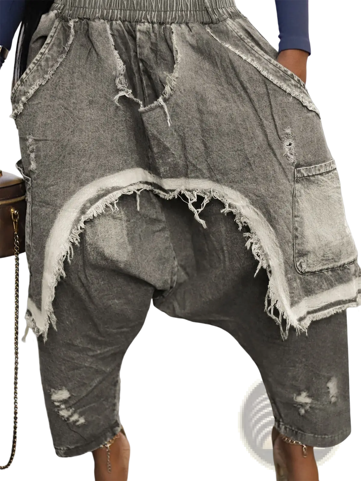 Distressed patchwork denim harem pants in gray with frayed edges and a relaxed, loose fit
