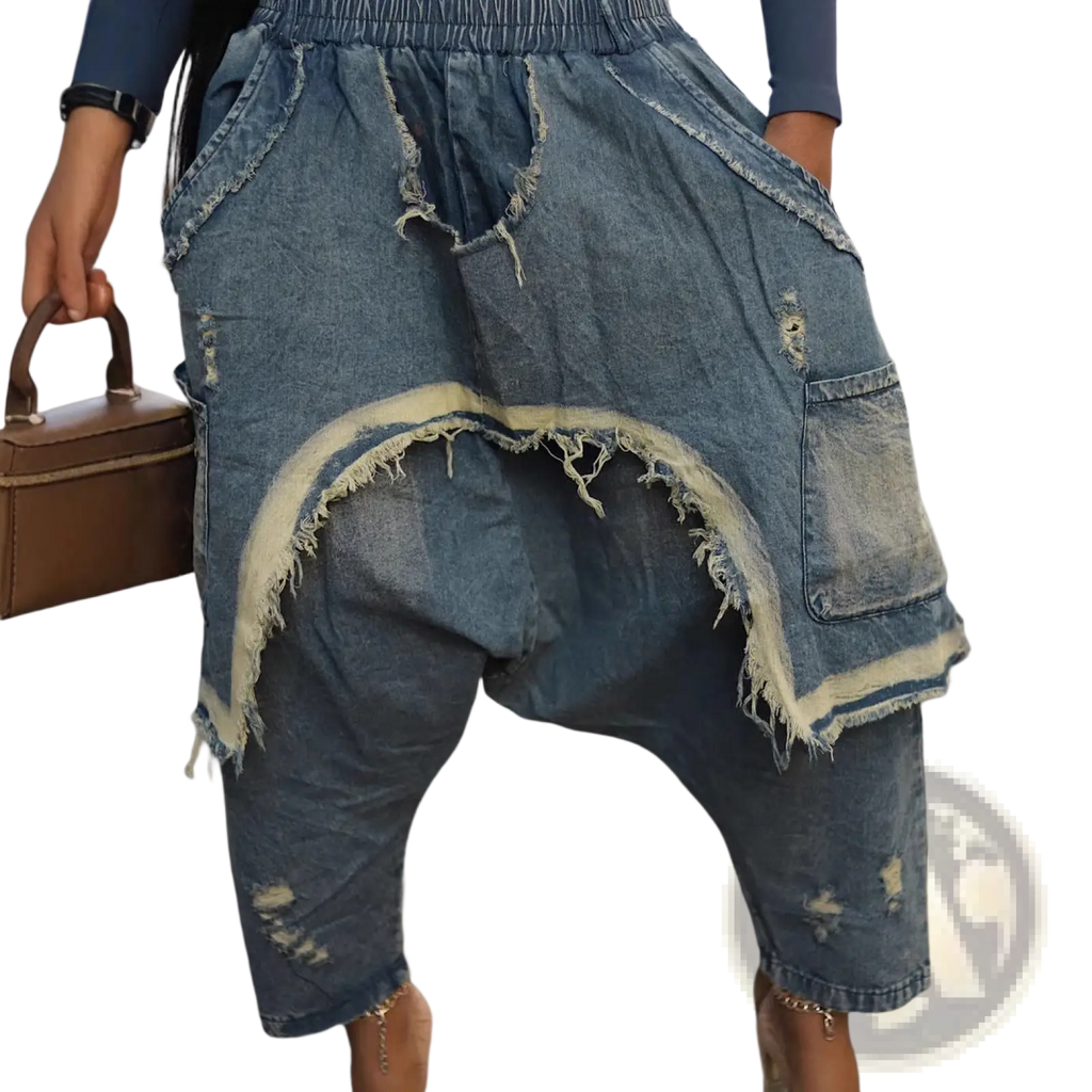 Distressed patchwork denim harem pants in faded blue with frayed edges and a relaxed fit