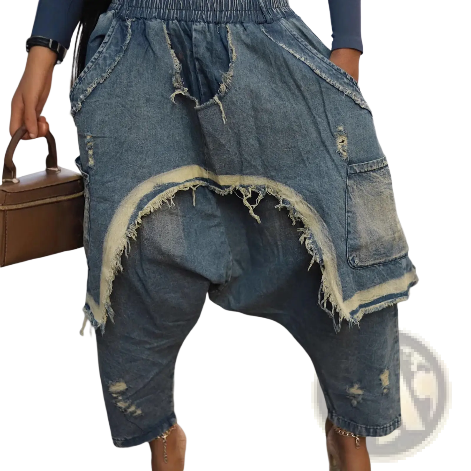 Distressed patchwork denim harem pants in faded blue with frayed edges and a relaxed fit