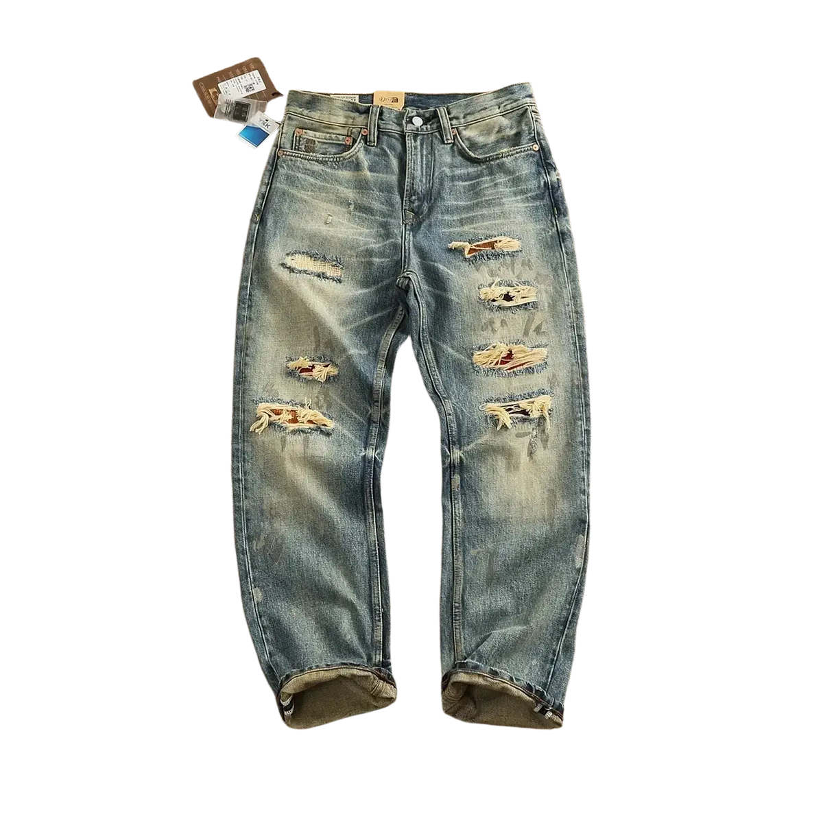 Distressed patchwork denim jeans men in light wash featuring multiple ripped patches and frayed edges for a casual look