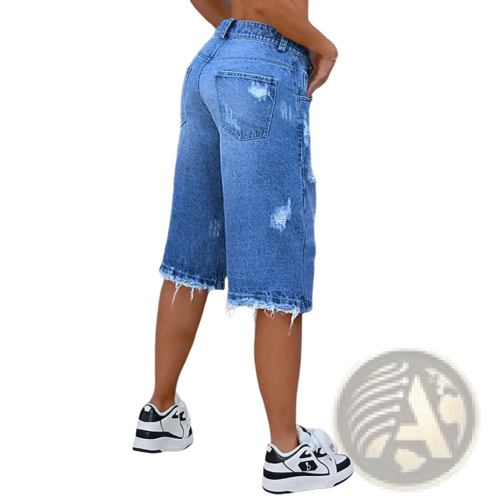 Blue distressed ripped denim capri pants featuring frayed hems made from durable denim material