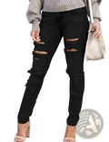 Black distressed ripped skinny denim pants featuring multiple ripped patches and frayed edges in denim material