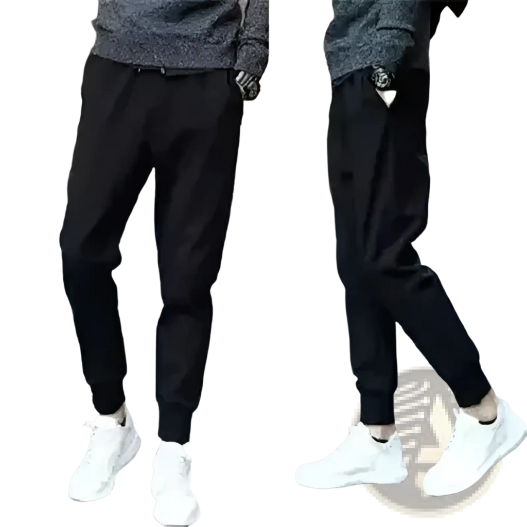 Black jogger pants with elastic cuffs and relaxed fit shown with distressed slim fit light wash denim jeans
