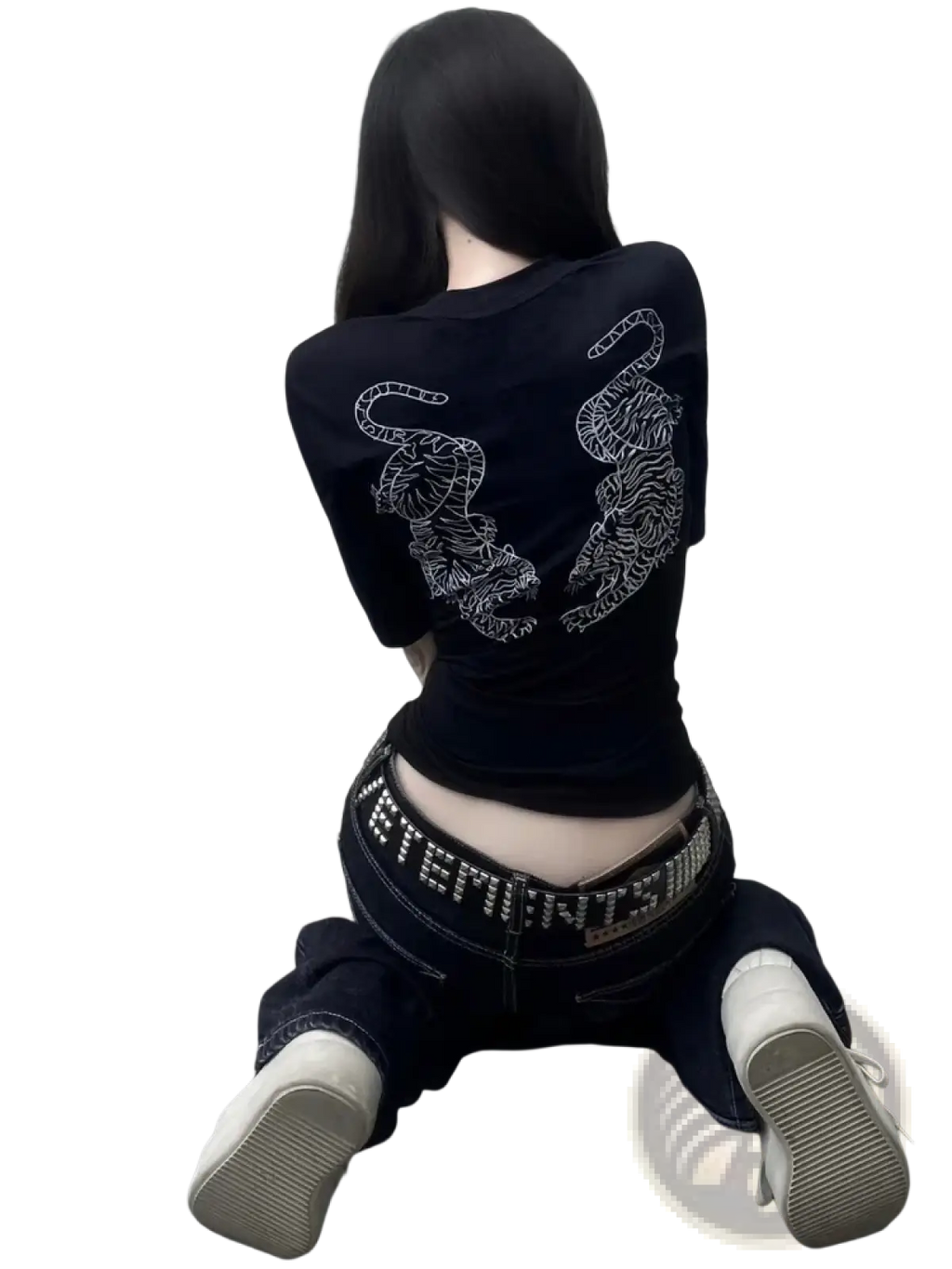 Black short-sleeved crop top with intricate white tiger embroidery on the back paired with distressed black denim jeans