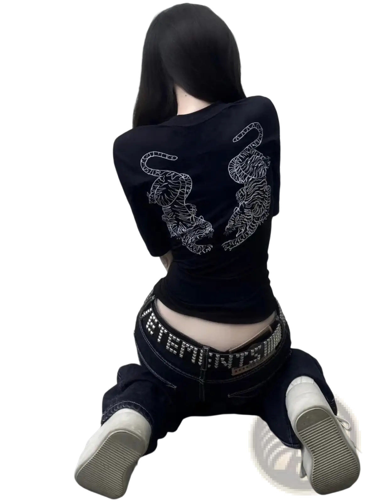 Black short-sleeved crop top with intricate white tiger embroidery on the back paired with distressed black denim jeans
