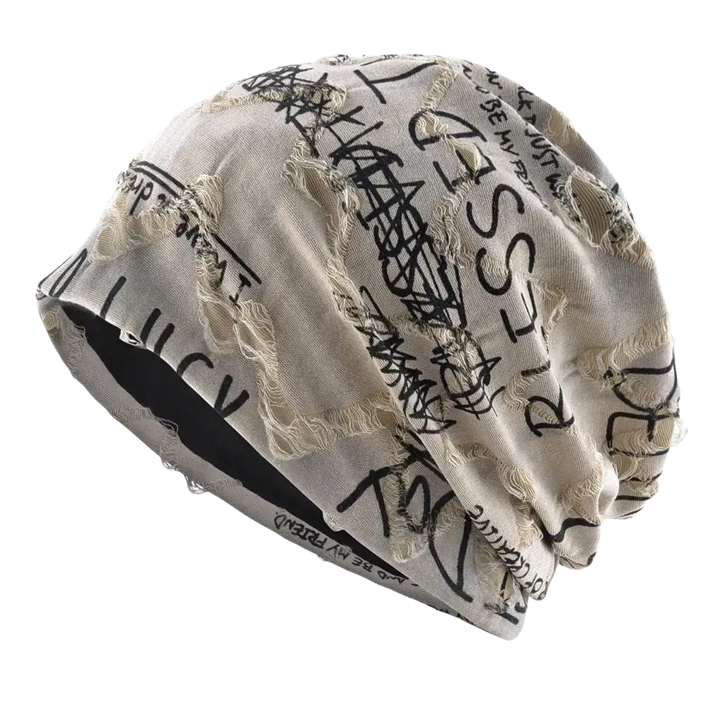Beige distressed streetwear beanie hat with black graffiti style lettering and frayed edges made from soft fabric