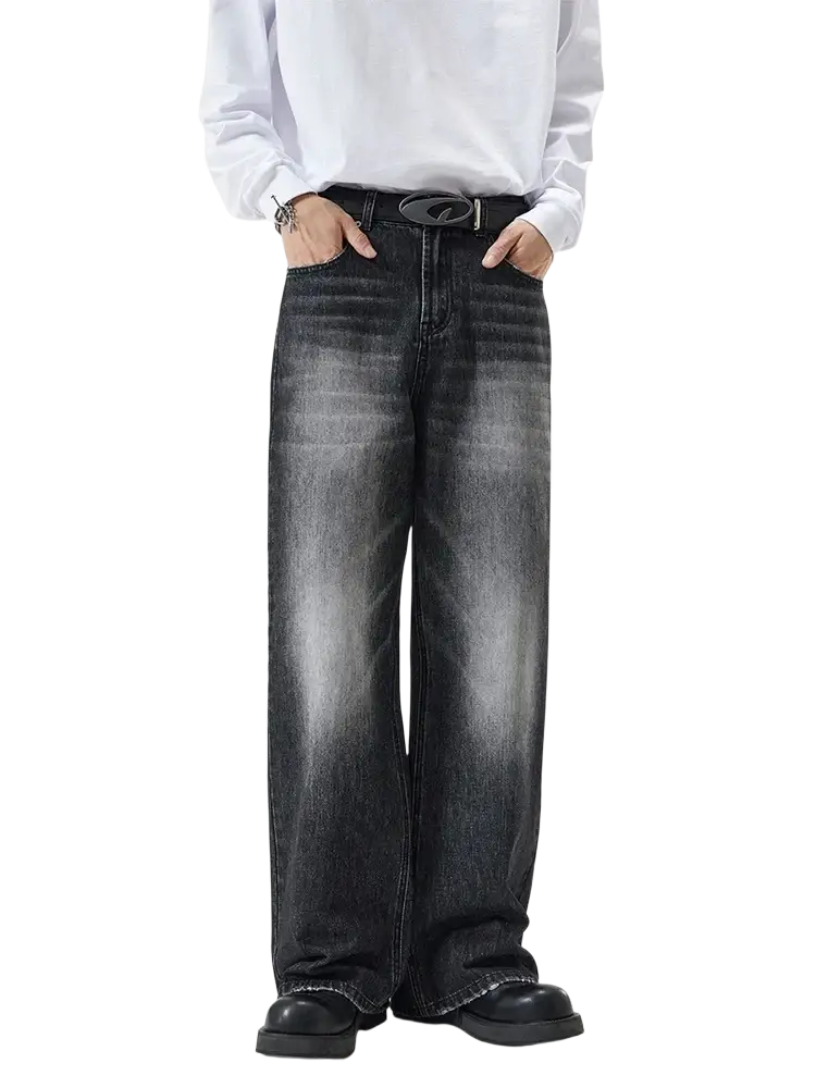 Distressed vintage baggy men denim jeans in dark wash wide-leg style with faded look and black belt accessory