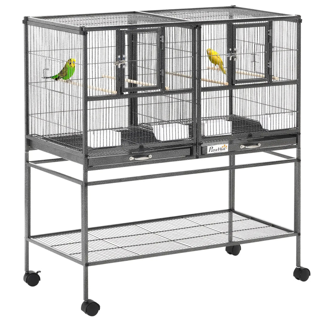 Black metal divided breeder bird cage with two compartments housing a green and yellow parakeet on perches