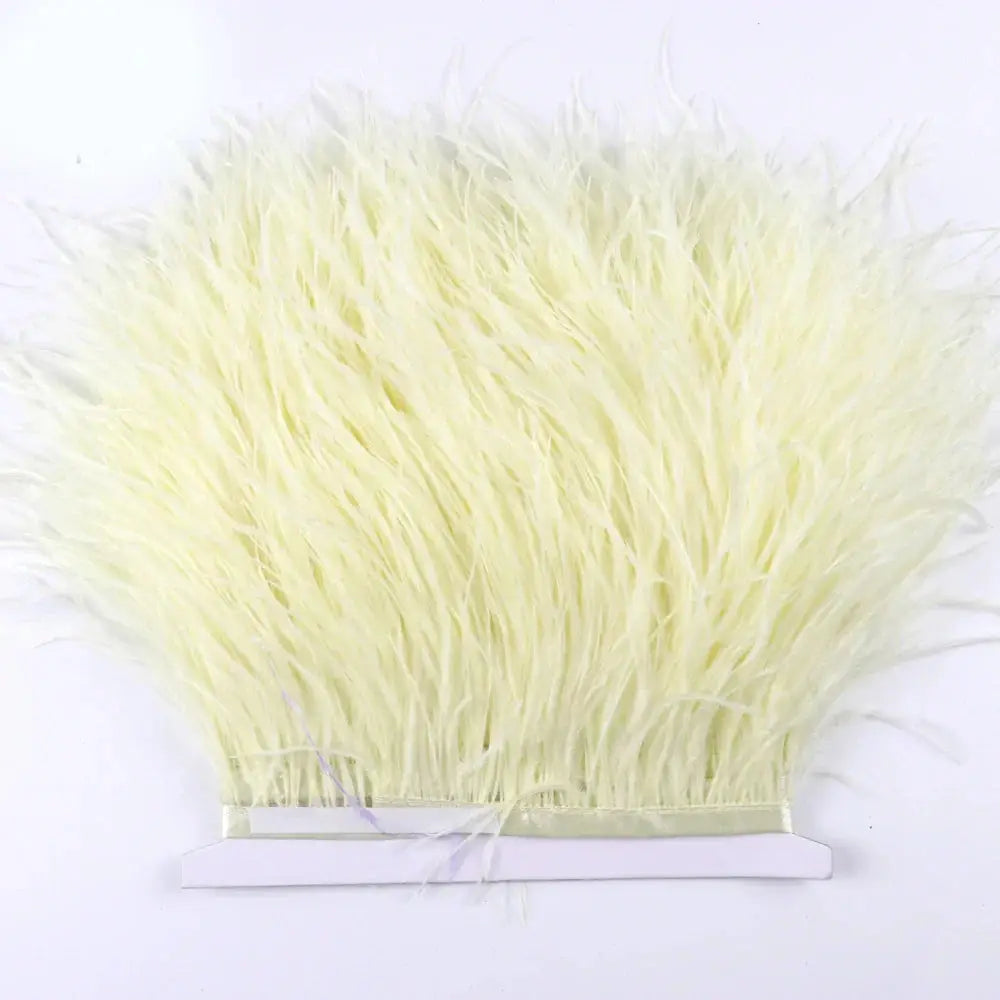 A bundle of pale yellow premium ostrich feather fringe trim neatly tied for diy fashion projects
