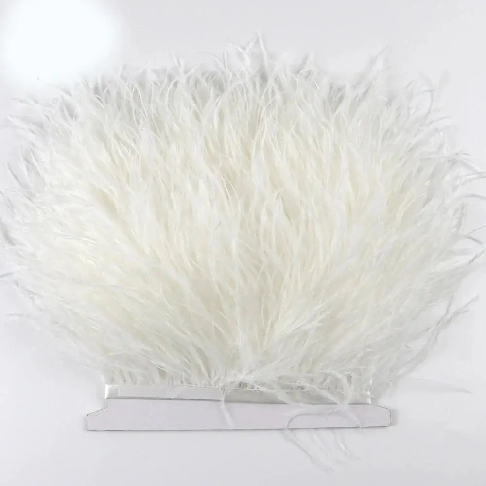 Premium feather fringe and ostrich trim in fluffy white displayed on a clear acrylic stand for diy fashion projects