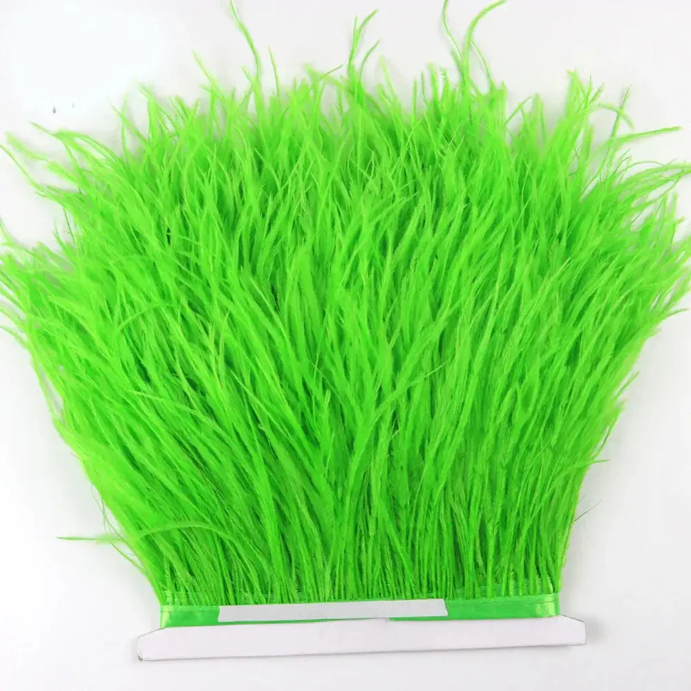 Premium feather fringe and ostrich trim in bright neon green synthetic grass with dense feathery texture and uniform length