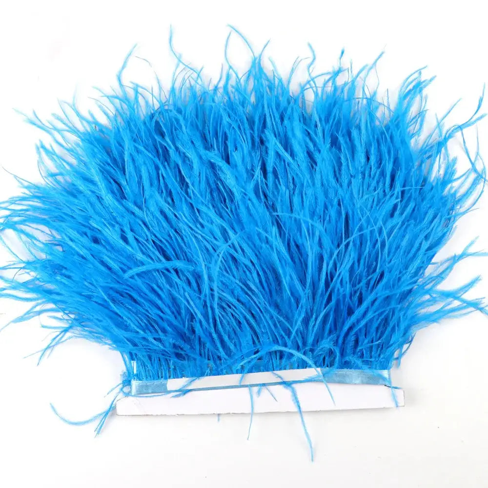 Bright blue synthetic feather trim with dense fluffy texture and white adhesive backing for diy fashion use