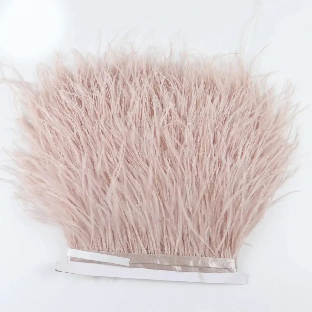 Premium feather fringe and ostrich trim with soft blush pink feathers, dense fluffy texture, and neatly bound edges for diy fashion